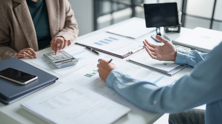 Image of Company Financials Discussion Between two People