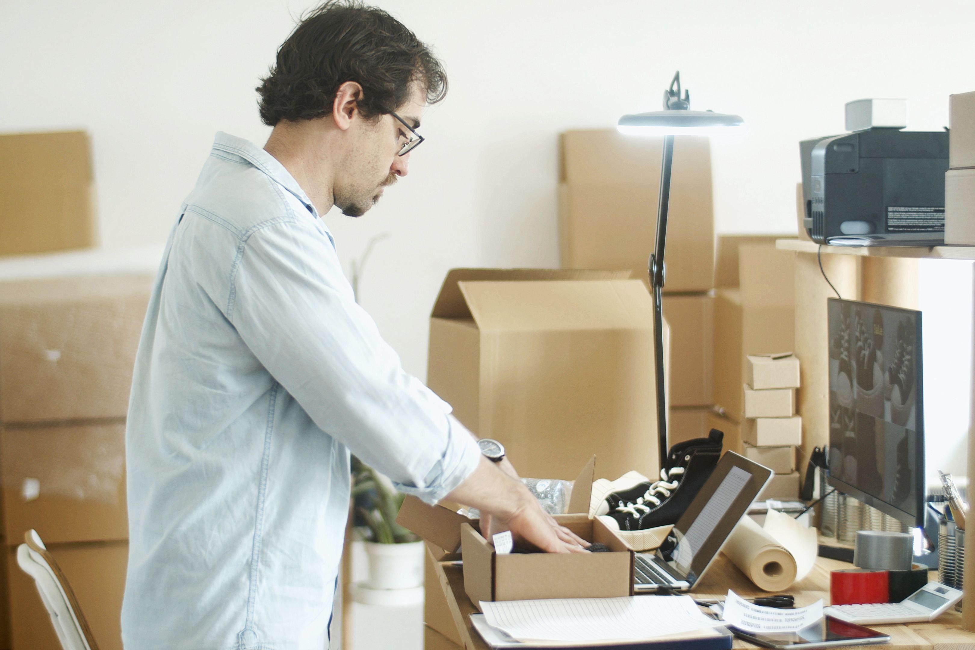 Image of an online seller packing a parcel