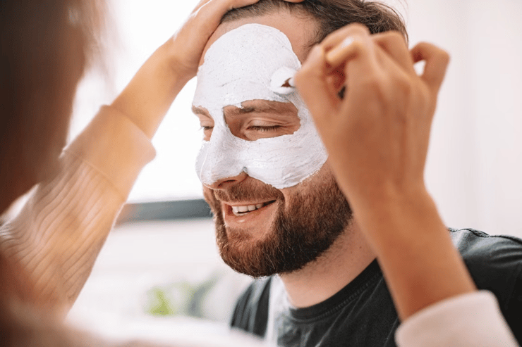 Man being face painted white