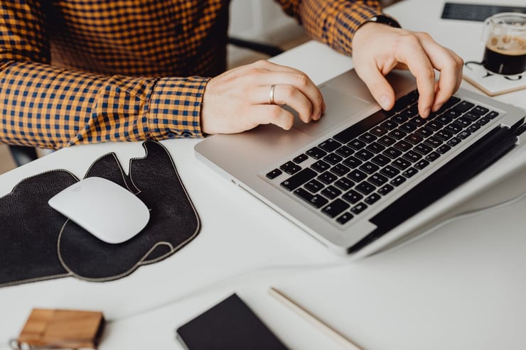 an image of hands working on a laptop
