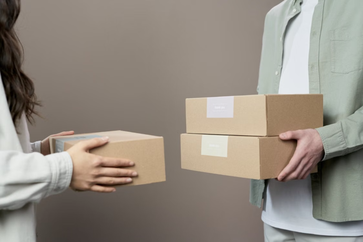 Two people holding boxes