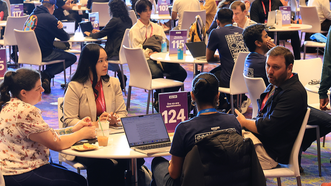 an image showing four people sitting on a table