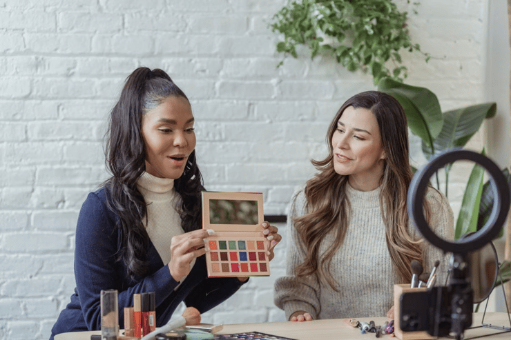 Woman showcasing makeup to a customer