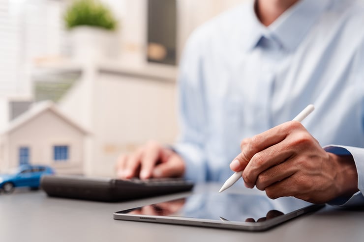 an image showing a man using a stylus on a tablet