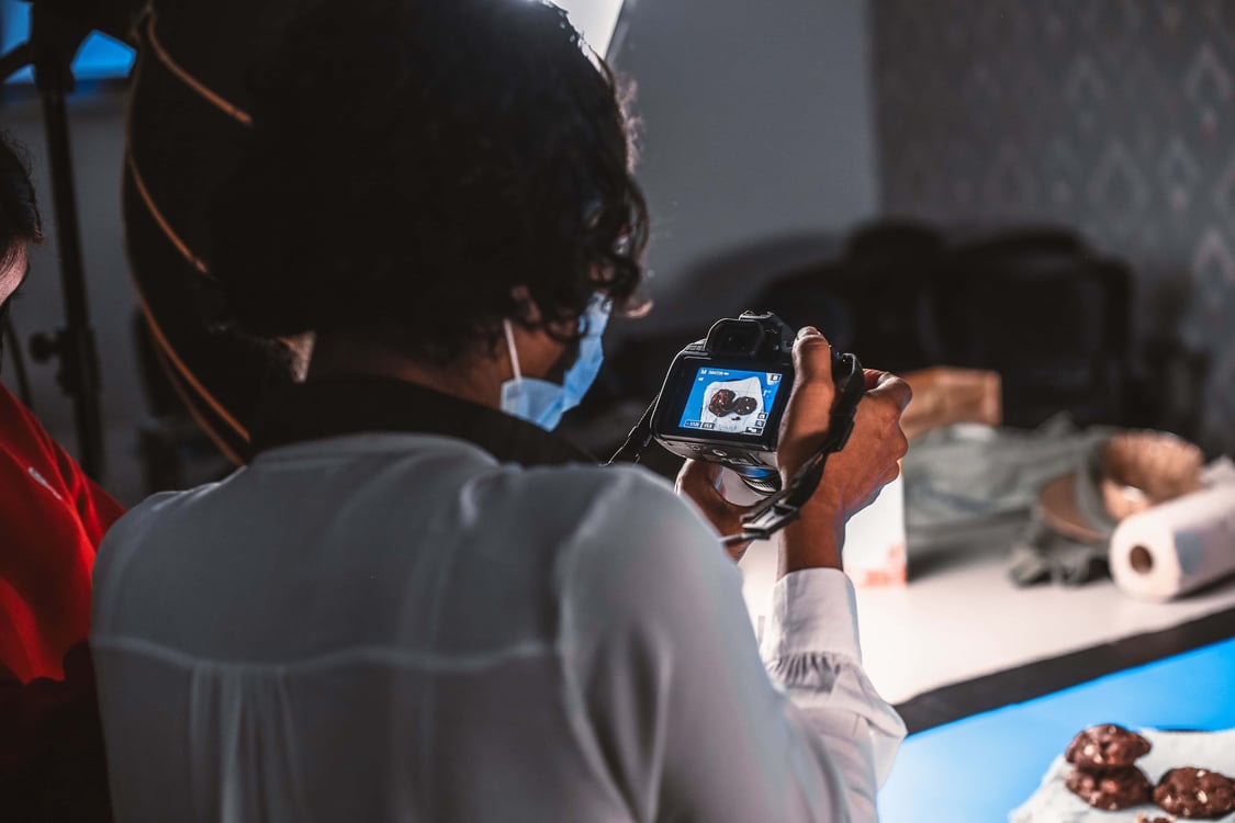 Photographer capturing a dessert setup with studio lighting