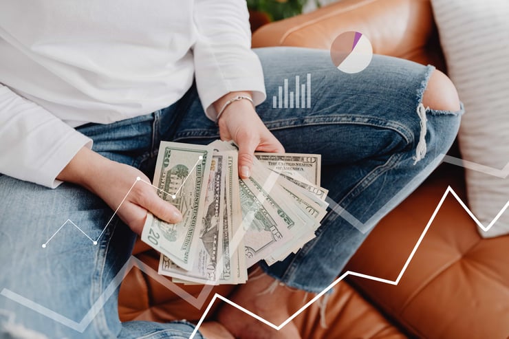 Person with dollars in hand, sitting, financial graphics overlay showing growth